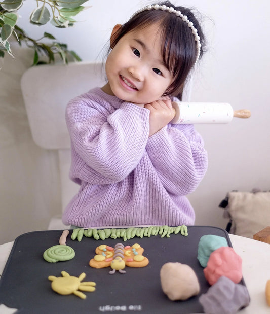 Child enjoying imaginative Bio DoUgh play with colourful creations