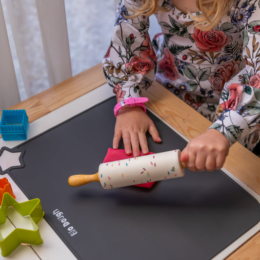 Child using a Bio DoUgh rolling pin during fine motor play