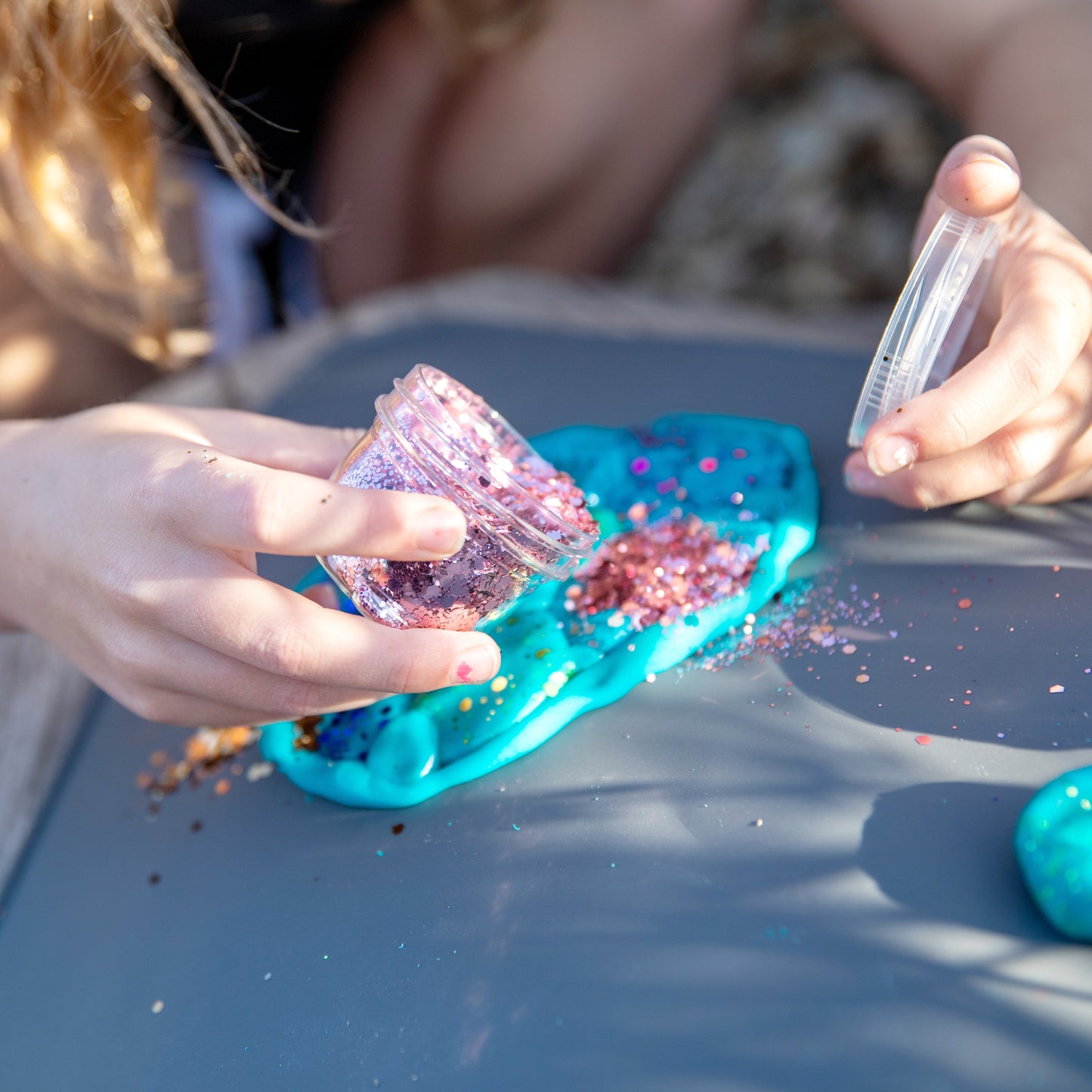 Close-up of eco-friendly dusty pink glitter in jar for kids crafts