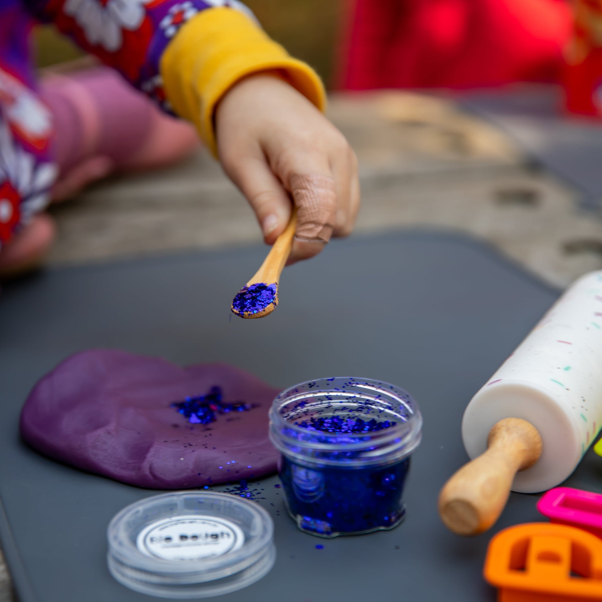 Close-up of eco-friendly electric glitter in jar for kids crafts