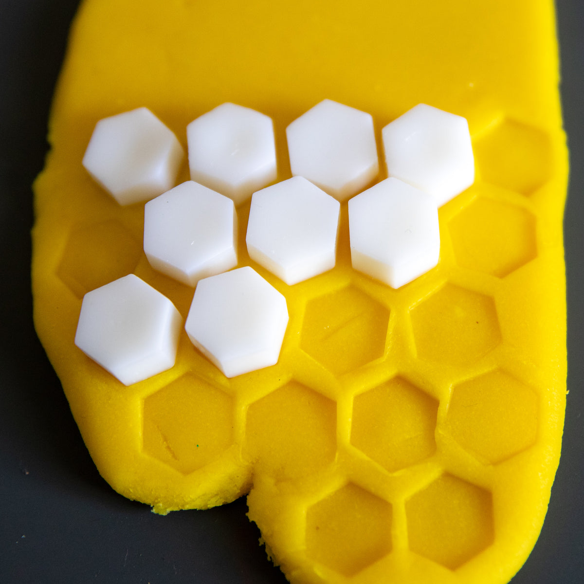White Bio DoUgh Blocks arranged on yellow playdough in a honeycomb pattern