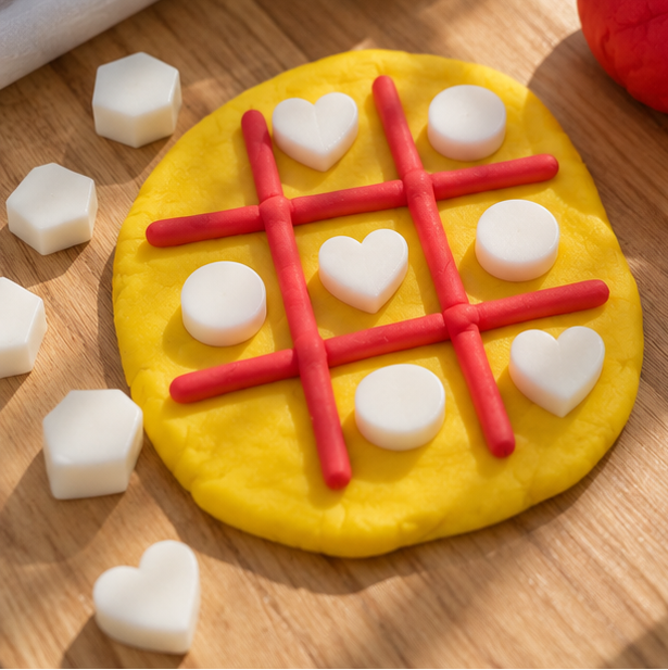Yellow playdough tic-tac-toe activity with white Bio DoUgh Blocks