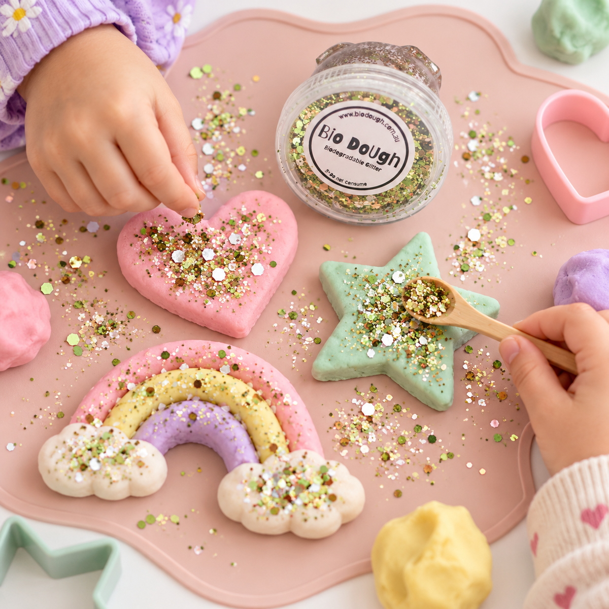 Children using Dino Mix biodegradable glitter with colourful Bio DoUgh for creative sensory play