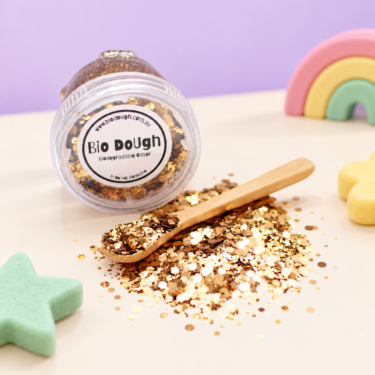 Golden biodegradable glitter with bamboo spoon and colourful Bio DoUgh playdough shapes
