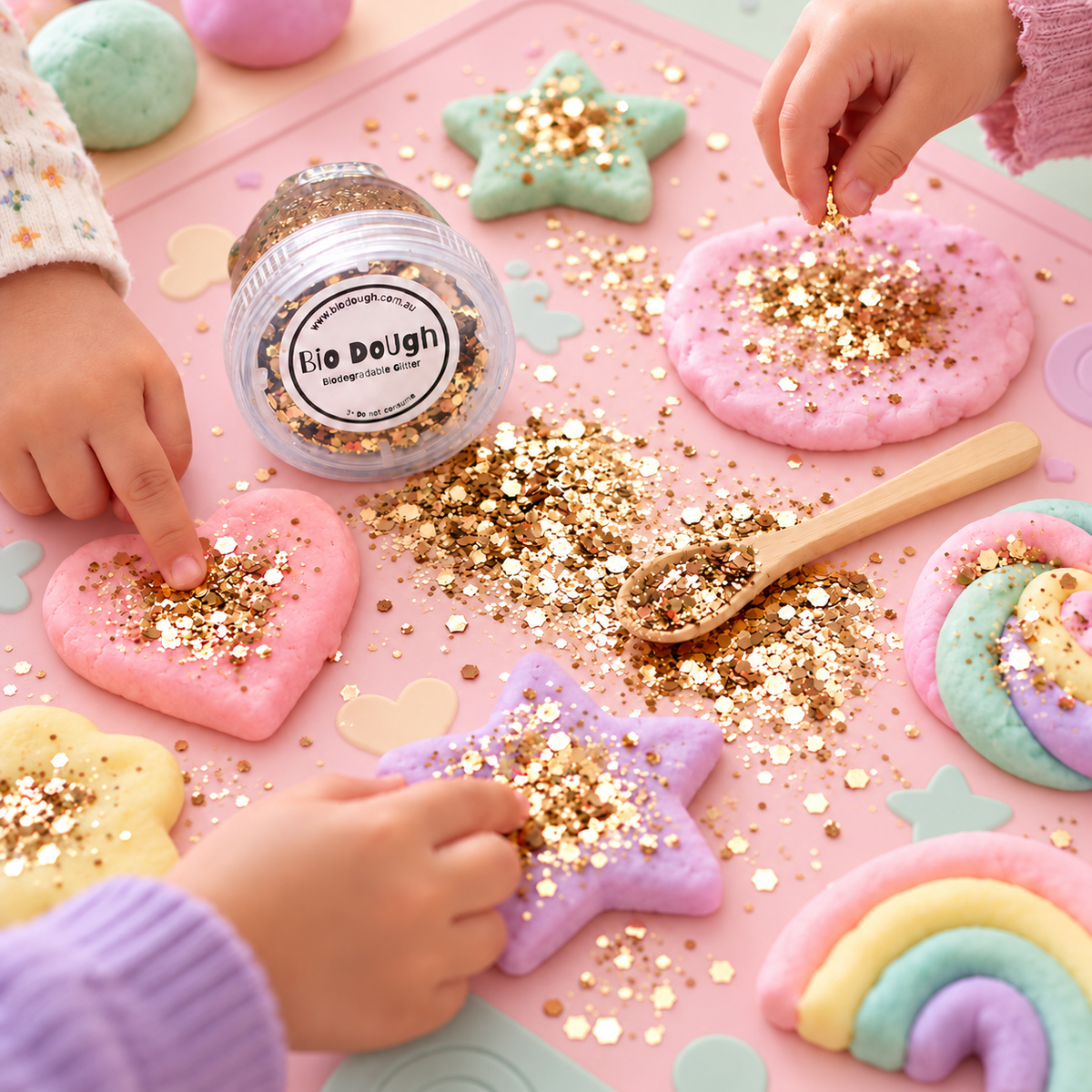 Children adding Golden Bio DoUgh glitter to colourful playdough creations during sensory play