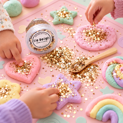 Children adding Golden Bio DoUgh glitter to colourful playdough creations during sensory play