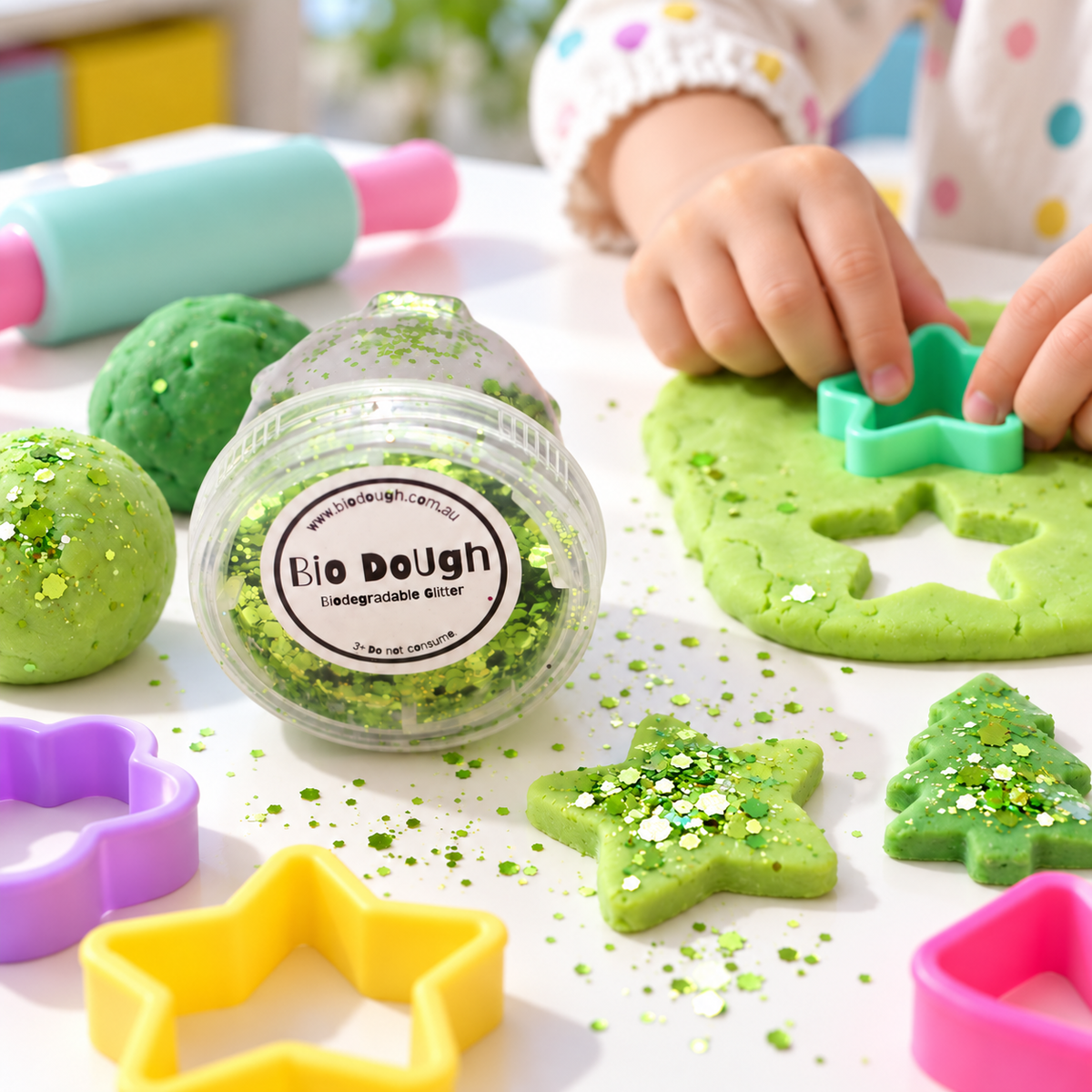 Child creating with green Bio DoUgh playdough and biodegradable green glitter