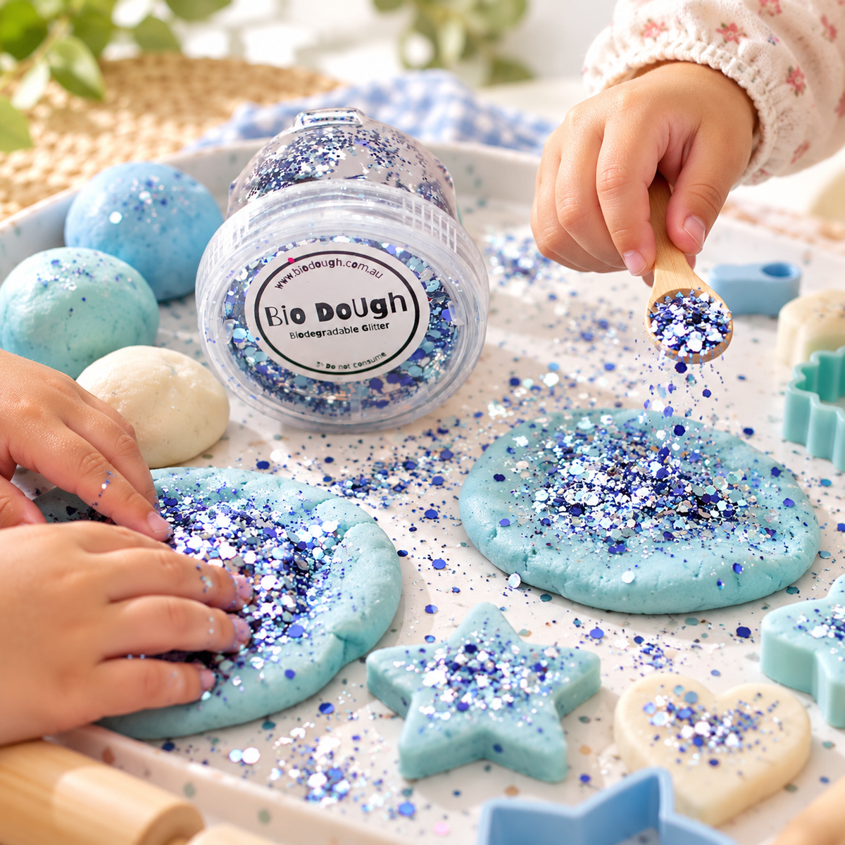 Children using Marine Mix biodegradable glitter with blue Bio DoUgh for ocean-inspired sensory play